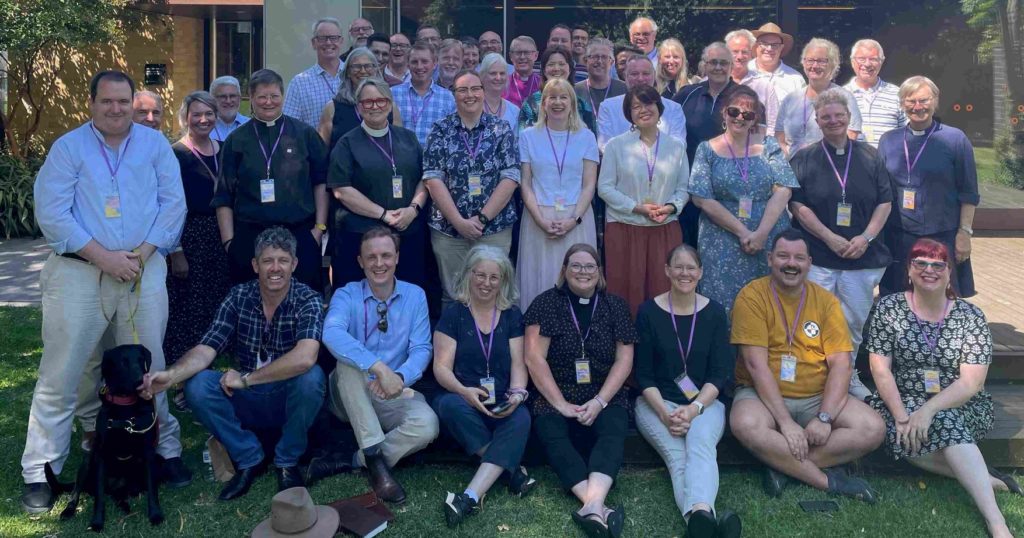 A group of people smiles at the camera